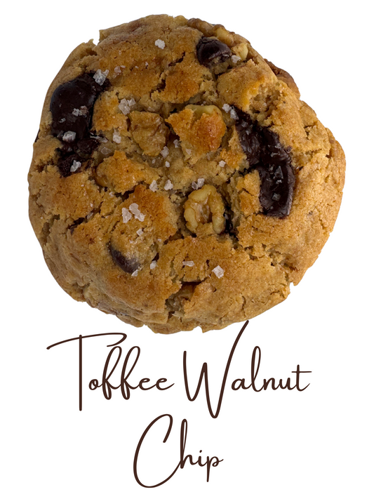 Picture of the Toffee Walnut Chip cookie with text label on a white background. Cookie shows chunks of chocolate chips, walnut, and sea salt.